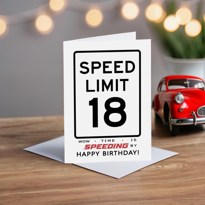 Celebrate their 18th birthday with our Speed Limit Birthday Card, beautifully displayed alongside a classic red model car.