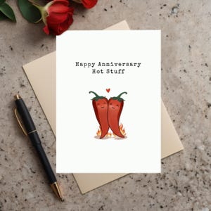 This charming card features two adorable hot peppers hugging in love, complete with a flame underneath to symbolize their fiery love. The message, Happy Anniversary Hot Stuff, adds a romantic and fun vibe -perfect for celebrating your special day
