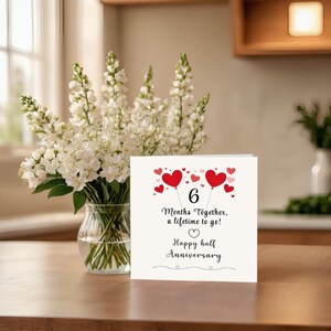 Celebrate your 6 month anniversary with a card featuring red and pink hearts, a heartfelt message '6 months together, a lifetime to go!' This elegant design beautifully captures the joy of your 6 month milestone.