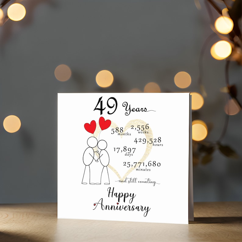 Mark your 49 year anniversary with a delightful card showcasing a gold heart and intertwined heart balloons held by stick figures. This charming 5" x 5" card is beautifully presented in the accompanying screenshot.