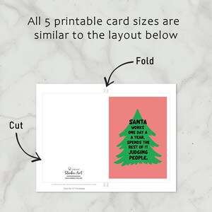 Brighten someone’s holiday with a cheerful Christmas card featuring a playful take on the holiday season! The card has a salmon-colored background that really pops against the large green Christmas tree silhouette in the center. The tree has a rough, hand-painted appearance with jagged edges, giving it a charming and homemade feel. In bold, black, handwritten-style font, the text "SANTA WORKS ONE DAY A YEAR, SPENDS THE REST OF IT JUDGING PEOPLE" All 5 cards can be printed, cut and folded