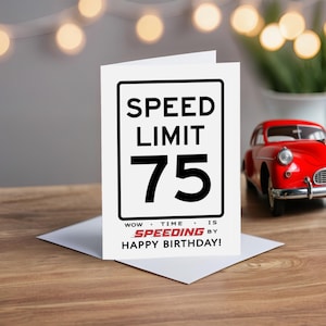Celebrate their 75th birthday with a charming Speed Limit Birthday Card, beautifully displayed alongside a classic red model car. This delightful pairing adds a nostalgic touch to their special birthday.