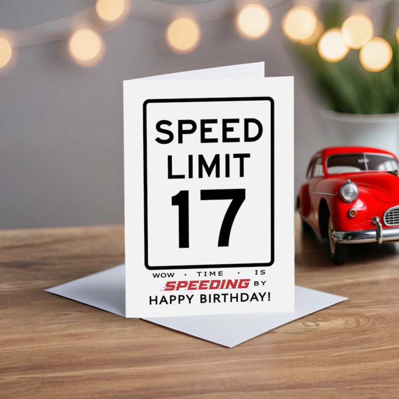 Celebrate their 17th birthday with a charming Speed Limit Birthday Card, beautifully displayed alongside a classic red model car. This delightful pairing adds a nostalgic touch to their special birthday.