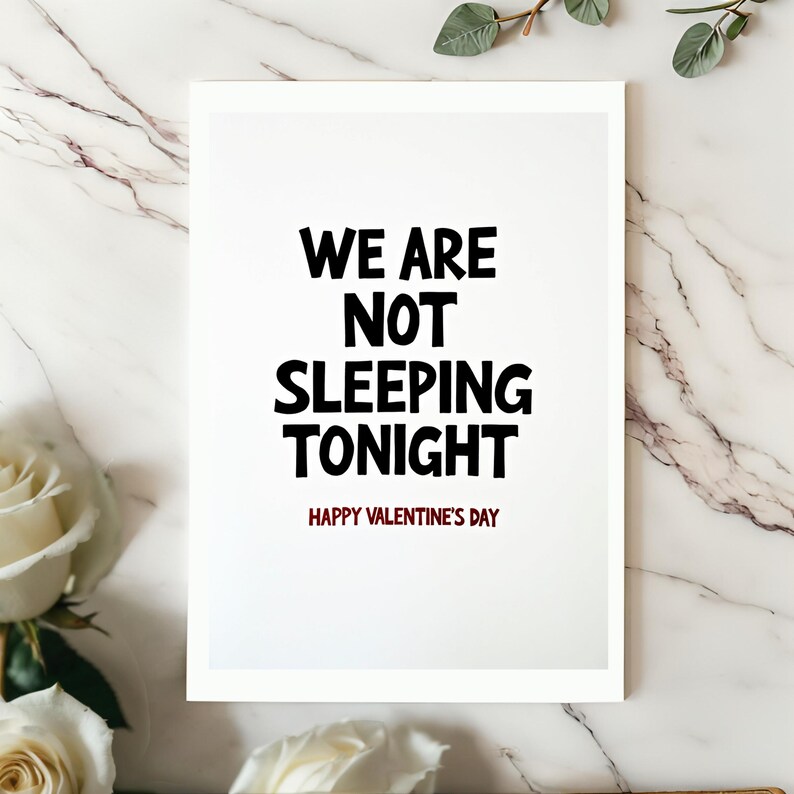 Funny Valentine card displayed on a white surface. The minimalist design highlights the bold text We are not sleeping tonight with a red Happy Valentines Day line.