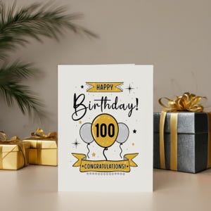 Honor their 100th birthday with our lovely Happy 100th Birthday Card, showcased next to birthday presents. This charming card adds a special touch, enhancing their celebration and making their milestone birthday even more memorable.