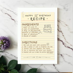 Mark their 77th with a unique recipe card, blending love, dreams, and adventure. Displayed with flowers on a wooden table, it’s a creative way to wish them a happy 77th birthday.
