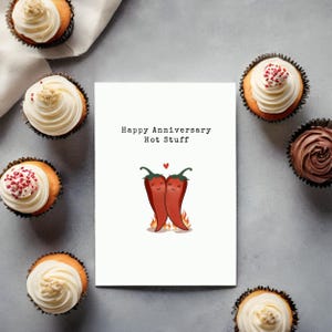 This cute anniversary card features 2 adorable hot peppers hugging in love, complete with a flame underneath to symbolize their fiery love. The message, Happy Anniversary Hot Stuff, adds a romantic vibe, perfect for celebrating your special day