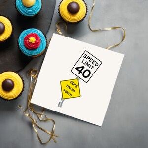 Celebrate their 40th birthday with a delightful 'Oops You Hit 40' Birthday Card, displayed next to cupcakes. This charming combination adds a memorable touch to their special day, symbolizing the start of an exciting new chapter in their life.
