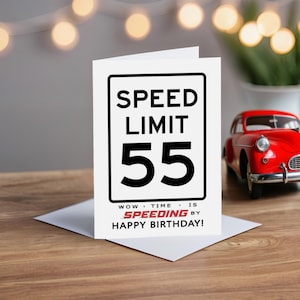 Celebrate their 55th birthday with a charming Speed Limit Birthday Card, beautifully displayed alongside a classic red model car. This delightful pairing adds a nostalgic touch to their special birthday.
