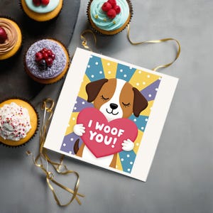 Dog-themed Valentine greeting card displayed next to cupcakes. A lovable puppy holds a pink heart with the words I Woof You, set on a colorful dotted background.