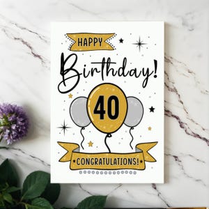 Celebrate their 40th birthday with our elegant Happy 40th Birthday card, beautifully presented next to purple flowers on a white granite countertop.