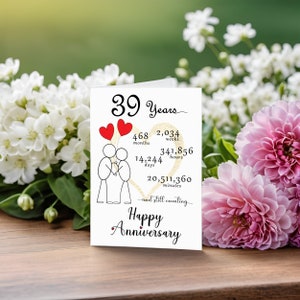 Mark your 39 year anniversary with a captivating card adorned with a gold heart, two intertwined heart balloons held by stick figures, and a backdrop of softly faded flowers, adding a touch of timeless elegance to your special day.