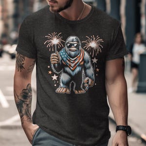 Bigfoot T-Shirt, Patriotic Bigfoot Graphic Tee, Bigfoot Fireworks Shirt, Funny Sasquatch Independence Day Tee, Unique Bigfoot Gift