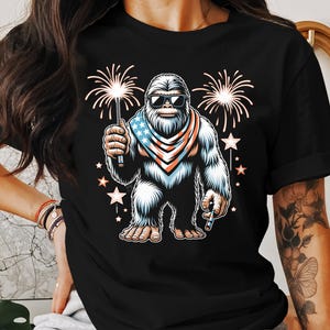 Bigfoot Patriotic T-Shirt, 4th of July Bigfoot Shirt, Sasquatch Fireworks Tee, Funny USA Shirt, Independence Day Yeti Top