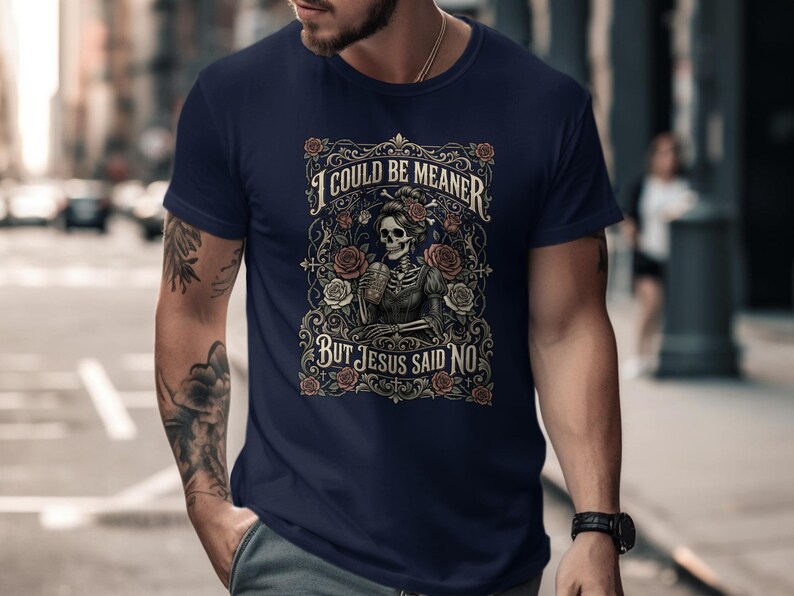 T-shirt with skeleton, roses, and text "I COULD BE MEANER BUT JESUS SAID NO".