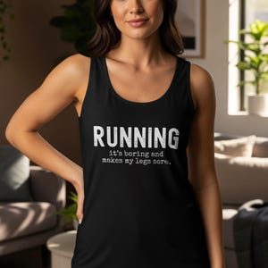 May include: Black tank top with the word "RUNNING" in white block letters. Below the word "RUNNING" is the text "it's boring and makes my legs sore." The tank top is worn by a person.