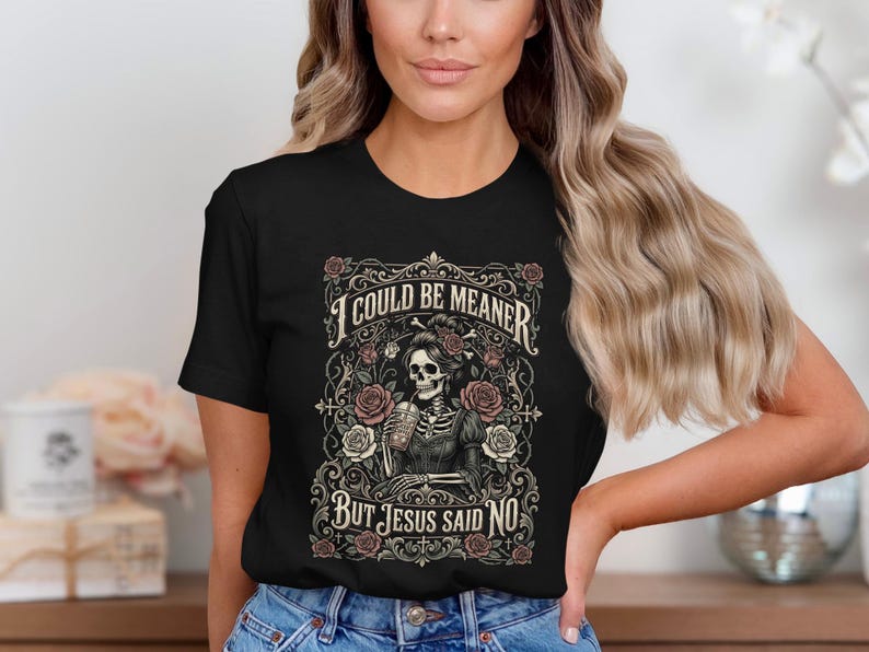 Black t-shirt with skeleton, roses, and text "I COULD BE MEANER BUT JESUS SAID NO".