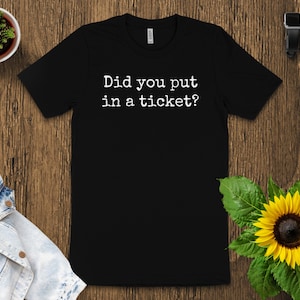 May include: Black t-shirt with white text that reads "Did you put in a ticket?"