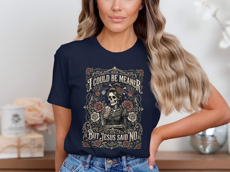 T-shirt with skeleton, roses, and text "I COULD BE MEANER BUT JESUS SAID NO".