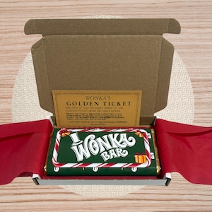 May include: A Wonka Bar chocolate bar in a cardboard box with a red interior. The bar is green with white and red candy cane stripes and the words "Wonka Bar". A golden ticket is visible inside the box.