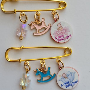 A  new baby girl and boy pin charm