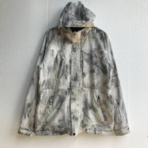May include: A white and black camouflage print hooded jacket with zipper closure and multiple pockets.