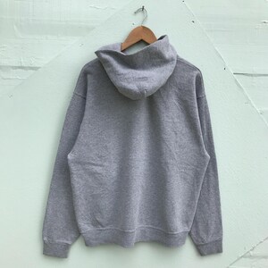 May include: A gray hooded sweatshirt with a drawstring hood. The sweatshirt has long sleeves and a kangaroo pocket.