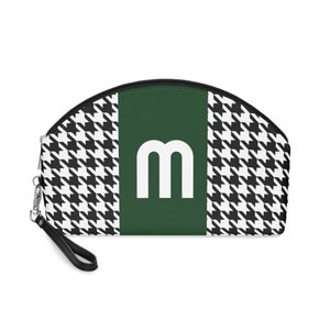 May include: A black and white houndstooth patterned cosmetic bag with a green stripe and a white letter "m" in the center.