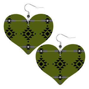 May include: Heart-shaped earrings with a Southwestern geometric pattern. The earrings feature a dark olive green background with black, gray, and white geometric shapes. The earrings have silver-colored hooks.