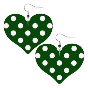 May include: A pair of heart-shaped earrings. Each earring is dark green with white polka dots. The earrings have silver-colored fish hook ear wires.