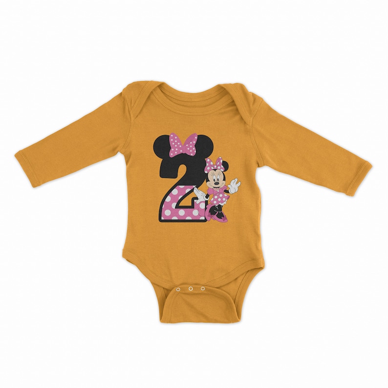 May include: A mustard yellow long-sleeved baby onesie with a pink and white polka dot number "2" and a cartoon image of Minnie Mouse wearing a pink dress and bow.