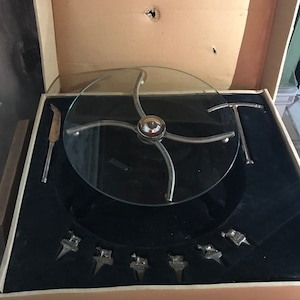 glass cheese platter with picks and knife goat cow sheep roquefort gouda silver metal the France cheeses turn volte