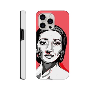 May include: A phone case with a black and white illustration of a woman's face on a pink background.