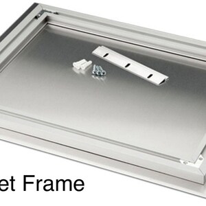 May include: A 3/4" inset frame kit, featuring a silver metal frame and backing. The kit includes mounting hardware: screws, wall anchors, and a metal bracket. The frame is designed for a flush, recessed installation.