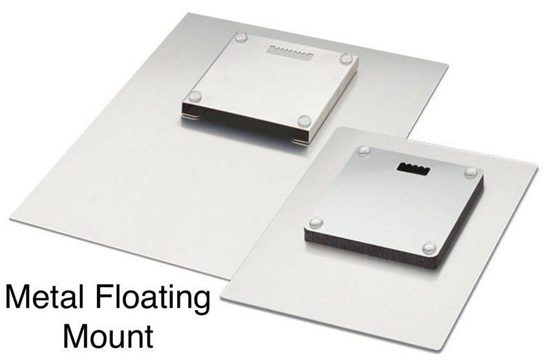 May include: Two metal floating mounts are shown, one larger than the other. Each has a square mounting plate with a keyhole for hanging and small rubber bumpers. The text "Metal Floating Mount" is visible.