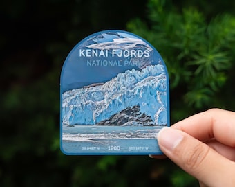 May include: A blue and white sticker with a photo of a glacier and the text "KENAI FJORDS NATIONAL PARK" and the coordinates "59.8487° N 150.1879° W" and the year "1980".