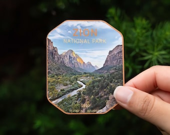 May include: A sticker featuring a scenic view of Zion National Park, Utah. The sticker is octagonal shaped and has a light blue background with a white cloud. The text "Zion National Park" is in gold lettering. The image shows a winding river flowing through a valley with mountains in the background. The text "1919" is in the bottom left corner of the sticker.