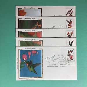 May include: A set of six first day of issue envelopes featuring hummingbirds. Each envelope has a different hummingbird species and a stamp with a hummingbird design. The envelopes are white with a gold border and the text "Humming Birds" printed on each envelope. The envelopes are dated June 15, 1992.