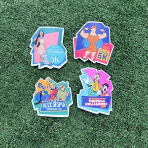 May include: Four colorful event stickers featuring Disney characters and event names. The stickers include Pocahontas, Hercules, Kuzcotopia, and Goofy. Each sticker has the text "2026 Virtual 5K" or "Virtual Challenge 2026".