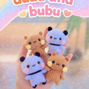 May include: Four crocheted bear-like amigurumi dolls in brown and lavender, each with black ears and a black stripe. The dolls have embroidered faces and yellow cheeks. The image includes the text "dudu and bubu" and "PDF Pattern".