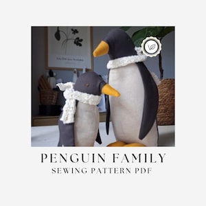 May include: Two handmade fabric penguin dolls in different sizes, each featuring dark grey backs, cream-coloured bellies, yellow beaks, and small white crocheted scarves. The text PENGUIN FAMILY SEWING PATTERN PDF is displayed below the two plush figures.