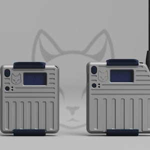 May include: Two silver electronic devices with a cat logo, a small screen, and a dark blue accent. One device has an antenna. The devices have a rectangular shape with vertical lines and a dark blue bar at the top and bottom.