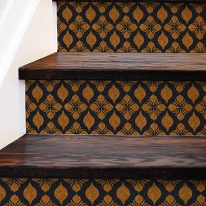 May include: A staircase featuring dark brown wooden treads and risers decorated with a repeating pattern of gold-colored, petal-shaped motifs set against a solid black background, creating a consistent geometric design across each step.