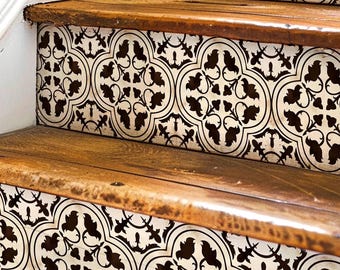 May include: Close-up of wooden stairs with black and white patterned tile decals. The decals feature a repeating geometric design with a floral motif.