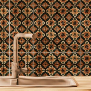 May include: A tiled kitchen backsplash featuring a repeating floral design in orange, black, and green. The tiles are above a sink and tap, creating a warm and inviting atmosphere. The tiles are likely ceramic.