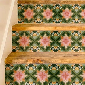 May include: A staircase featuring natural wood treads and risers decorated with a repeating geometric pattern in shades of forest green, soft pink, white, and muted orange, creating a symmetrical star-like motif across the vertical surfaces.