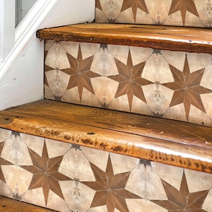 May include: Wooden stairs with a decorative tile pattern featuring brown stars on a beige background.