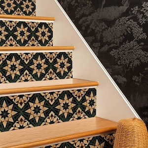 May include: A staircase featuring wooden steps and risers decorated with geometric decals in green, beige, and black. The wall is white with dark floral wallpaper. A woven basket sits at the base.