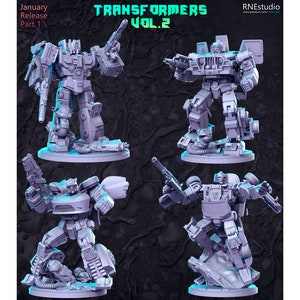 May include: Four gray 3D printed miniature robot figures, each with a different pose and holding a weapon. The figures are standing on circular bases. The text "TRANSFORMERS VOL.2" is printed at the top of the image.