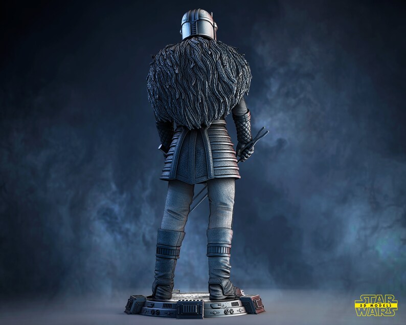 May include: A detailed, silver-colored figurine of a character from Star Wars wearing a fur-lined cloak and holding a lightsaber. The figurine is standing on a black base with the Star Wars logo.